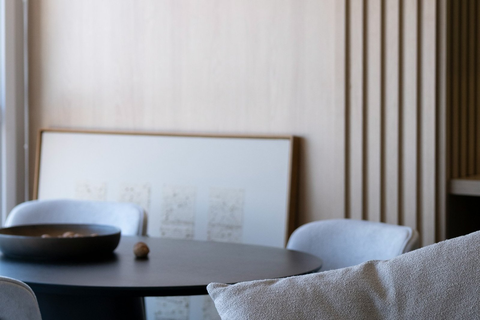 Quiet work and conversation corner with a round dark table beside a bright window